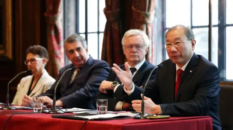 EPA British physician Neena Modi, human rights barrister Mark McDonald, Conservative MP David Davis and Professor Dr Shoo Lee speaking at a press conference