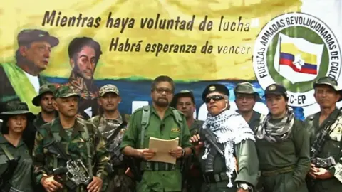 AFP This TV grab taken from youtube and released on August 29, 2019 shows former senior commander Ivan Marquez(C) and fugitive rebel colleague, Jesus Santrich(wearing sunglass),