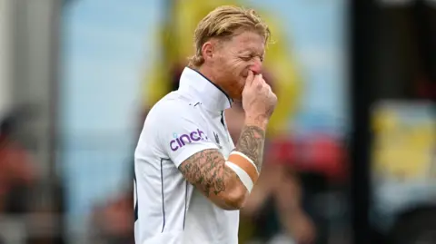 England captain Ben Stokes grimaces as he limps off the field injured