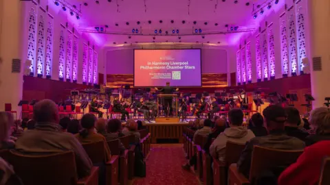 Liverpool Philharmonic/Chloe Lloyd An audience at the Liverpool Philharmonic watching a performance of the In Harmony orchestra