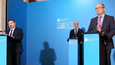 PA Media Health Minister Robin Swann, Chief Scientific Advisor Professor Ian Young and Chief Medical Officer Michael McBride