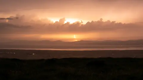 Nigel McFarland Shows a dark sky light up by lightning
