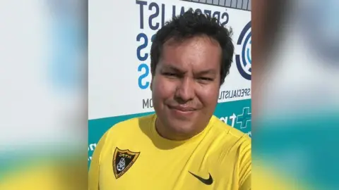 Supplied A selfie of Ricardo Pan wearing a yellow Harborough Town shirt