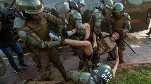 AFP A demonstrator is arrested by riot police during a protest for the death of Mapuche Camilo Catrillanca in Santiago, on November 15, 2018.