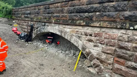 National Highways The north side of the bridge where about two metres (6ft) of concrete has been excavated