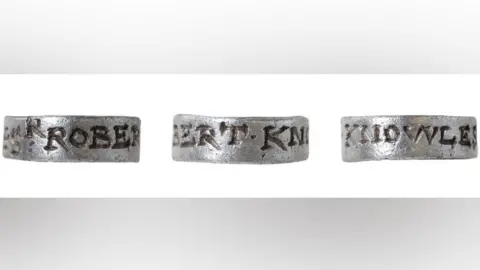 Three views of a silver hawking tag or vervel. It is engraved around its outside. The view on the left is engraved with the letters ROBER, the view in the middle has the letters BERT.KN and the view on the right has the letters KNOWLES.