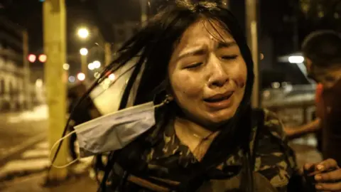 EPA An injured person reacts during a protest against the new government of President Manuel Merino, in San Martin de Lima square, in Lima, Peru, 14 November 2020