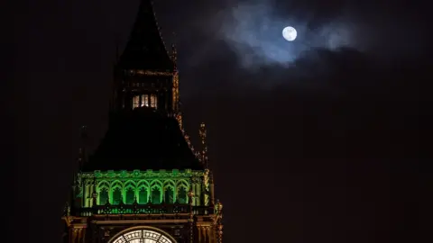 Getty Images The Ayrton light shining at the top of Elizabeth Tower