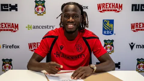 Wrexham wing-back Issa Kabore has re-joined the club