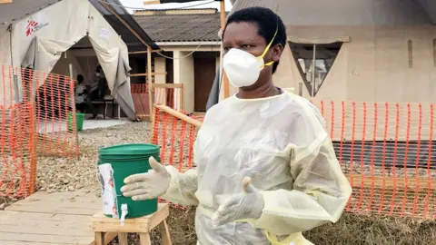 Mercy Juma / BBC Odette Nsavyimana wearing medical protective gear