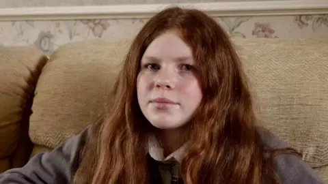 Phoebe sat on a sofa