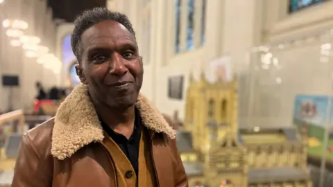 A man stands inside a church building