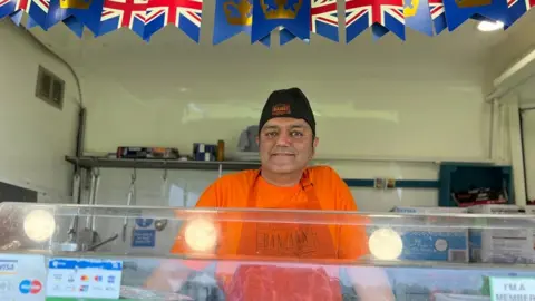 Emma Baugh/BBC Ajay Sabharwal on his Indian food stall