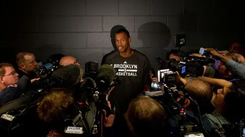Jason Collins #98 of the Brooklyn Nets speaks with the media prior to a game against the Denver Nuggets at Pepsi Center on February 27, 2014 in Denver, Colorado. 
