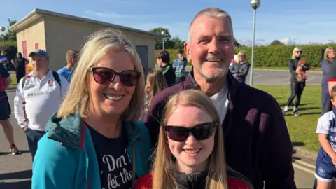 BBC/Jim Scott James Campbell stands with his wife and daughter.