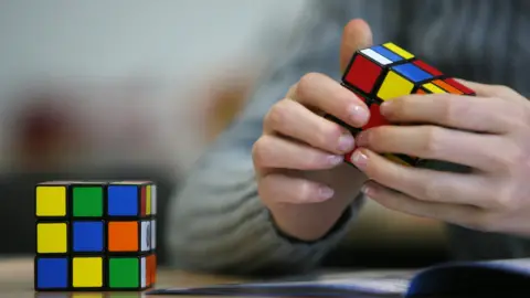 AFP/Getty A seventh grade student of the 'Free Christian' school in Duesseldorf trys out the Rubik's Cube for the first time on November 9, 2010.