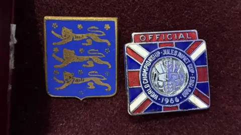 Two shiny football badges