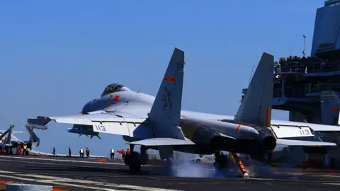 Getty Images A Chinese J15 fighter jet landing on an aircraft carrier, 24 April 2018