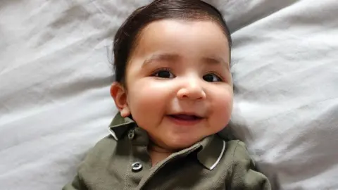 Supplied A photo of Aarav lying on a white sheet.