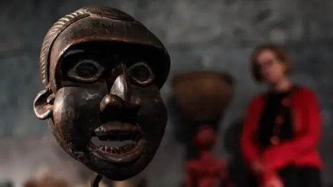 Getty Images A Runner Mask, 'Mabu' from the Wum people, Cameroon, 1930s (estimate £5500 - 7,500) stands during a press preview at Summers Place Auctions on May 30, 2018 in Billingshurst, England