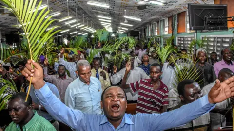 AFP People holding palm leaves in a church in Dar es Salaam, Tanzania - Sunday 5 April 2020
