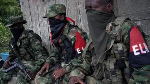 Reuters Rebels from Colombia's Marxist National Liberation Army (ELN) take a rest outside a farmer's home, in the northwestern jungles, Colombia on 31 August 2017