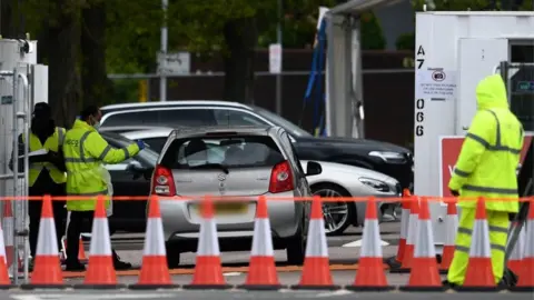 EPA A car arrives at an NHS coronavirus drive through testing facility at Lee Valley Leisure Centre in London,