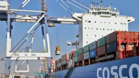 Reuters A container is unloaded from a China Ocean Shipping Company (COSCO) cargo vessel at a port in Yantai, Shandong province, China