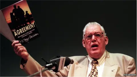 Pacemaker Ian Paisley holding a copy of the Good Friday Agreement Booklet