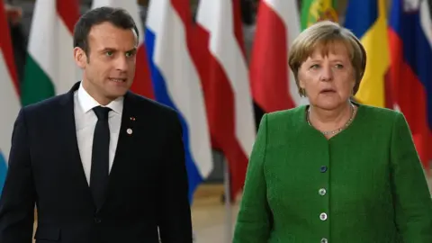 Getty Images France's President Emmanuel Macron and Germany's Chancellor Angela Merkel arrive for an informal meeting of the 27 EU heads of state in Brussels, 23 February 2018