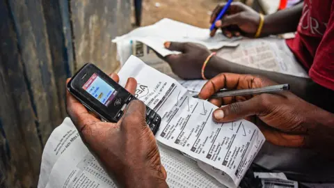 Getty Images Betting by mobile phone in Uganda