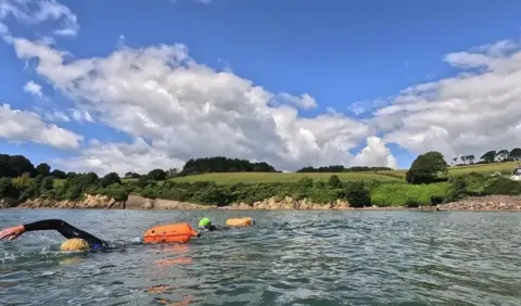 Emily Woodley A view of Coastguards Beach from the water, which also has swimmers in it