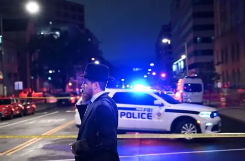 A man at a police cordon outside the shooting