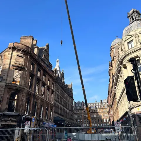 Glasgow City Council A view down Gordon Street of the facade of the building and the main entrance of Glasgow Central Station. The street is cordoned off and there is a crane.