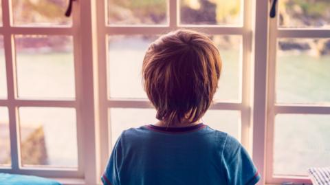 Boy looking out of window