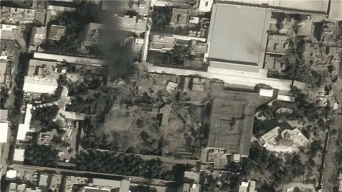 A satellite image shows black smoke rising above the compound of Leadership House, the office of Iran's Supreme Leader Ayatollah Ali Khamenei