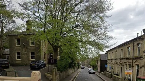 A road lined with light coloured stone buildings