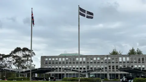 Lee Trewhella A St Piran's flag is seen blowing in the wind in front of Cornwall council buildings 