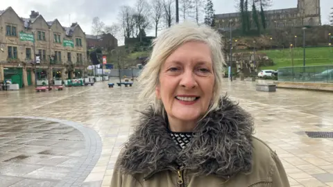 Photograph of Karen Boardman from the Rochdale Development Agency. The image is taken next to Rochdale Town Hall and the Flying Horse pub.