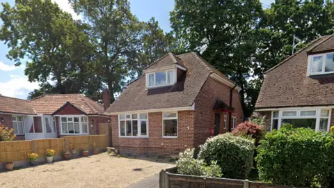 Google View from the street of 20 Southmead Road, Fareham, showing a bungalow with an upper level dormer window behind a gravelled front area. A row of tall trees are at the rear of the property.