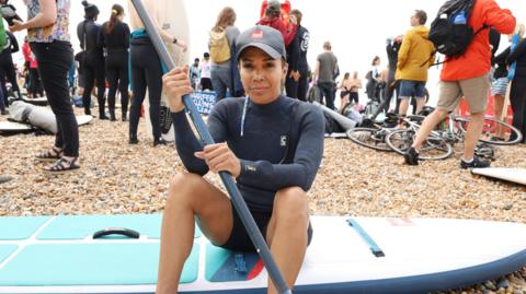 Dame Kelly Holmes on a paddleboard at Brighton Beach on Saturday