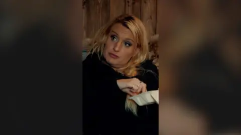 Daisy May Cooper with her hand in a takeaway box