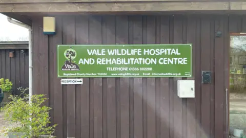 Vale Wildlife Hospital A wall with a green sign on it reading "Vale Wildlife Hospital and Rehabilitation Centre".