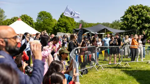 Nene Park Trust Crowds of people standing in front of a stage 