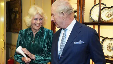 Queen Camilla and King Charles during a reception for authors, members of the literary community and representatives from the Queen's Reading Room, to celebrate the first recipients of the Queen's Reading Room Medal, at Clarence House,