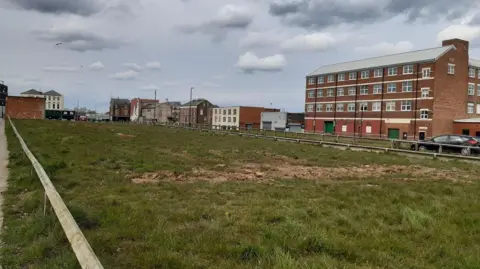 The site of the proposed housing development at Sunniside, currently a fenced-off field