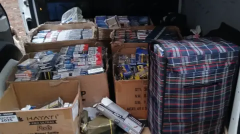 Boxes of cigarettes packed into the back of a van.