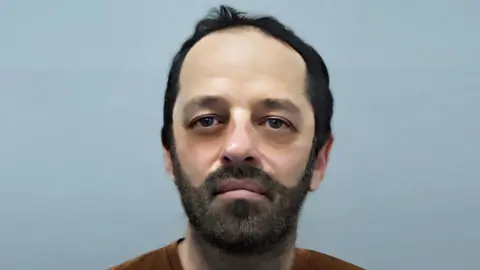 Thames Valley Police/PA E-fit of Neil Maxwell depicting him with a slimmer face and dark beard