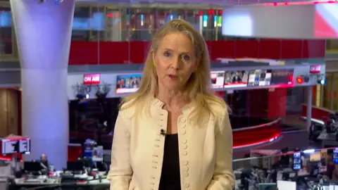 Caroline Hawley in a white jacket, facing the camera