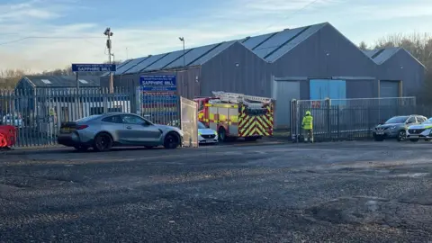 A fire engine parked in front of the Sapphire Mill in Leslie, Fife. Two other emergency vehicles can also be seen.